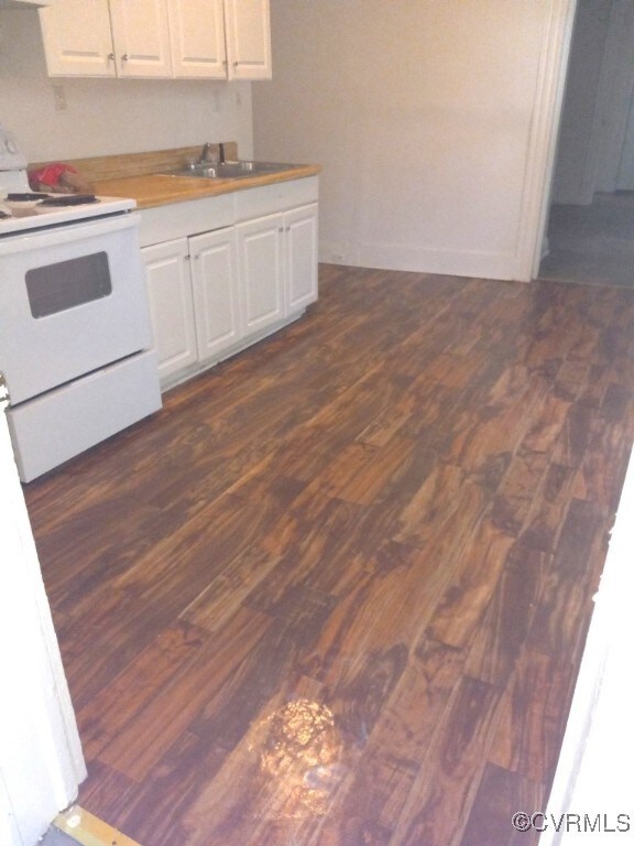 Kitchen featuring white range with electric cookto