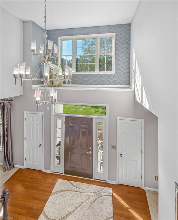 The Foyer featuring a dramatic chandelier, a tower