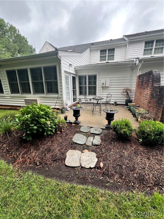 Back of house with a patio area
