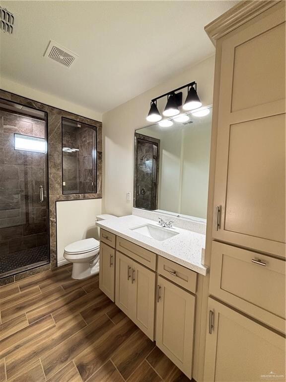 Bathroom with walk in shower, vanity, and toilet