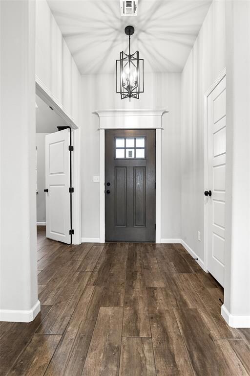 Entrance foyer with wood-type flooring, baseboards