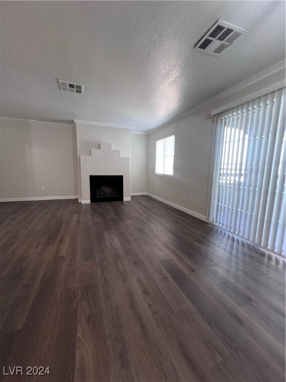 Unfurnished living room with ornamental molding, b