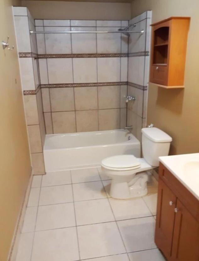 Bathroom featuring toilet, tile patterned floorin