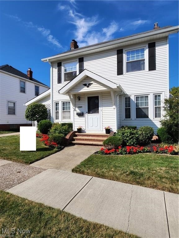 View of front of property with a front lawn