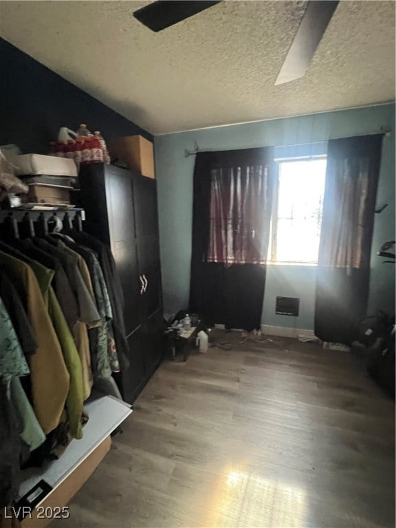 Bedroom featuring wood finished floors and a textu
