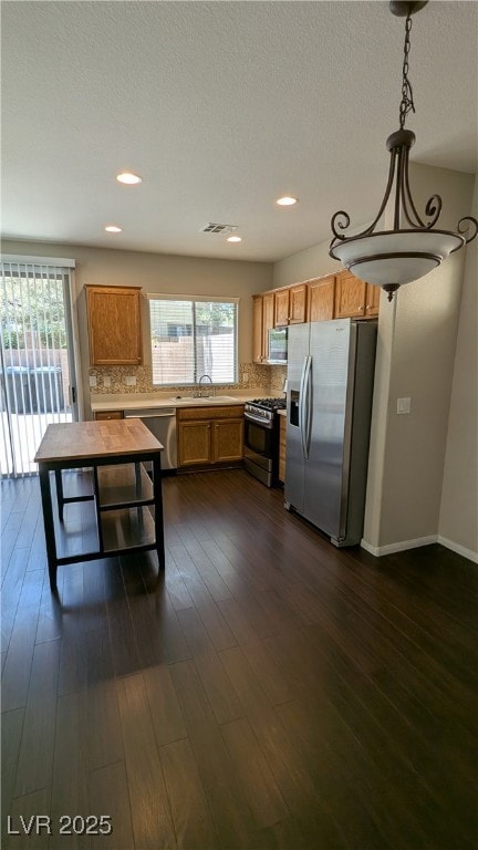 Kitchen featuring stainless steel appliances, back