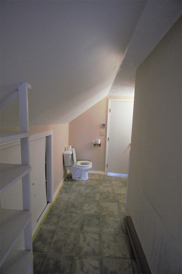 bathroom has a portable washer and dryer