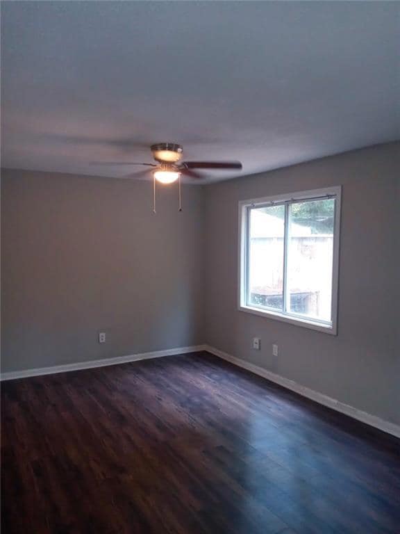 Spare room with ceiling fan and dark hardwood / wo