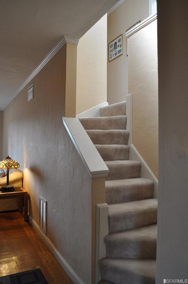 Staircase to 2 upper level bedrooms and 1 full bat