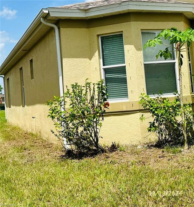 View of side of home with a lawn