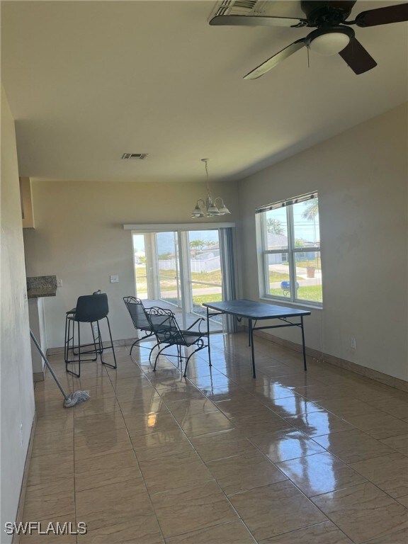 Game room featuring baseboards, a chandelier, and