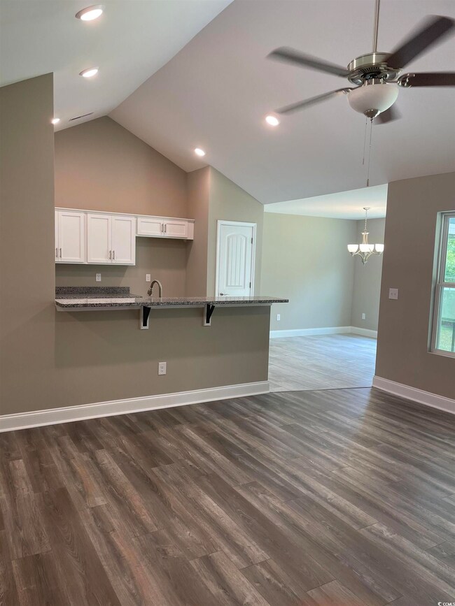 Kitchen with dark hardwood / wood-style flooring, 