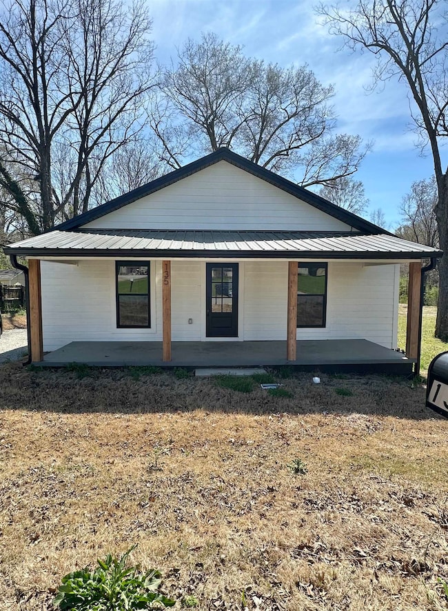 View of front of house featuring a porch, a standi
