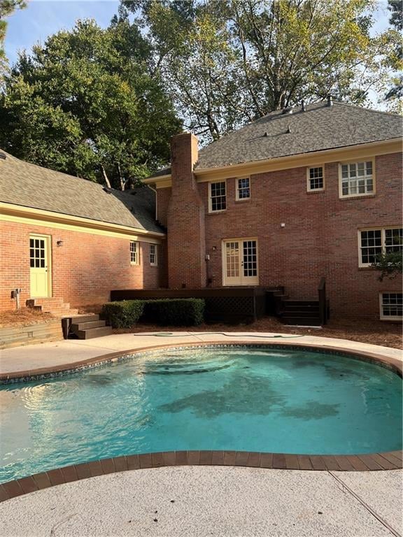 Outdoor pool featuring a patio