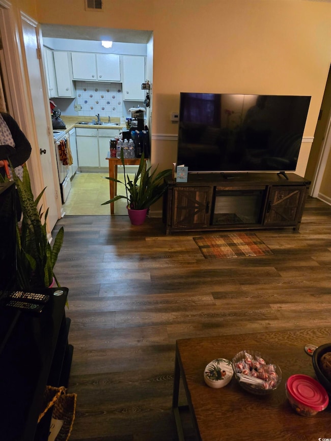 Living area with visible vents and wood finished f