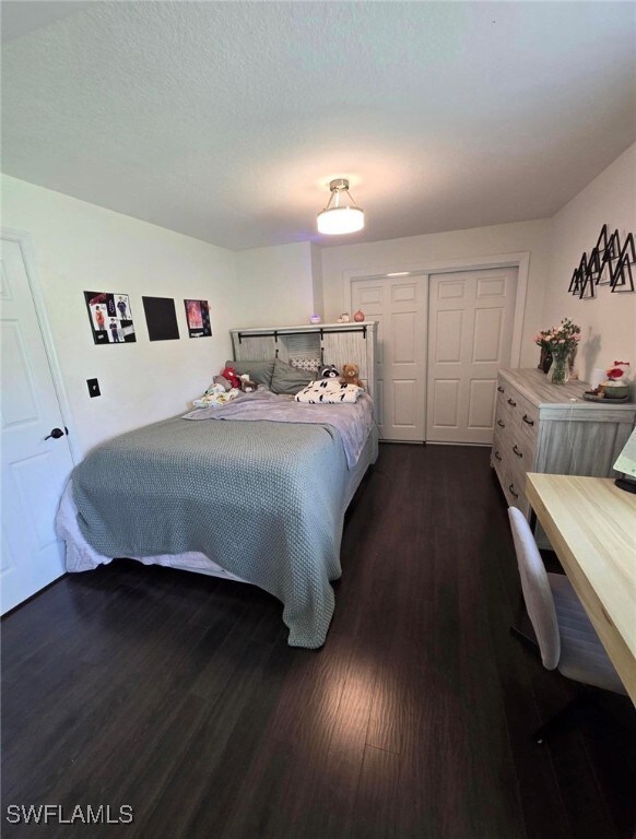 Bedroom featuring a textured ceiling, a closet, an