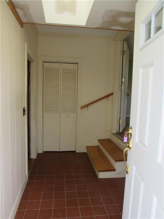 Foyer entry between the garage and...