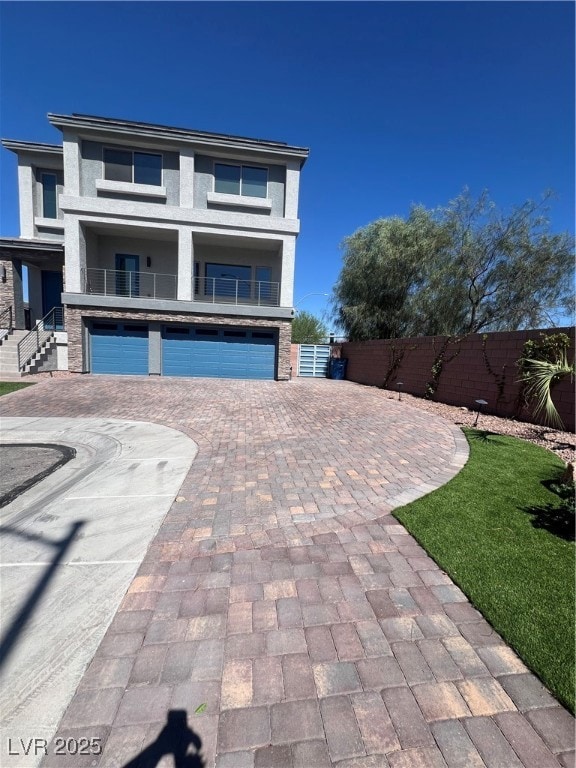 View of front of home featuring a garage, decorati