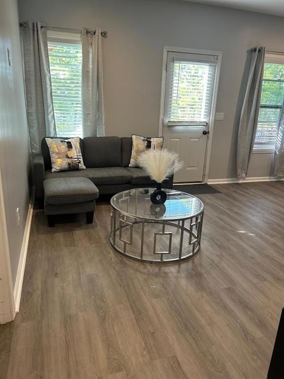 Living room with baseboards and wood finished floo