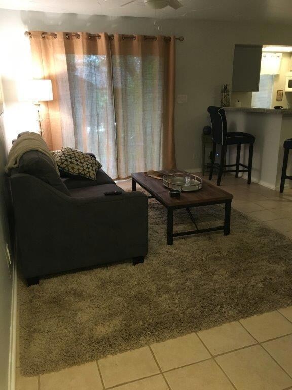 Living room with tile patterned flooring and ceil