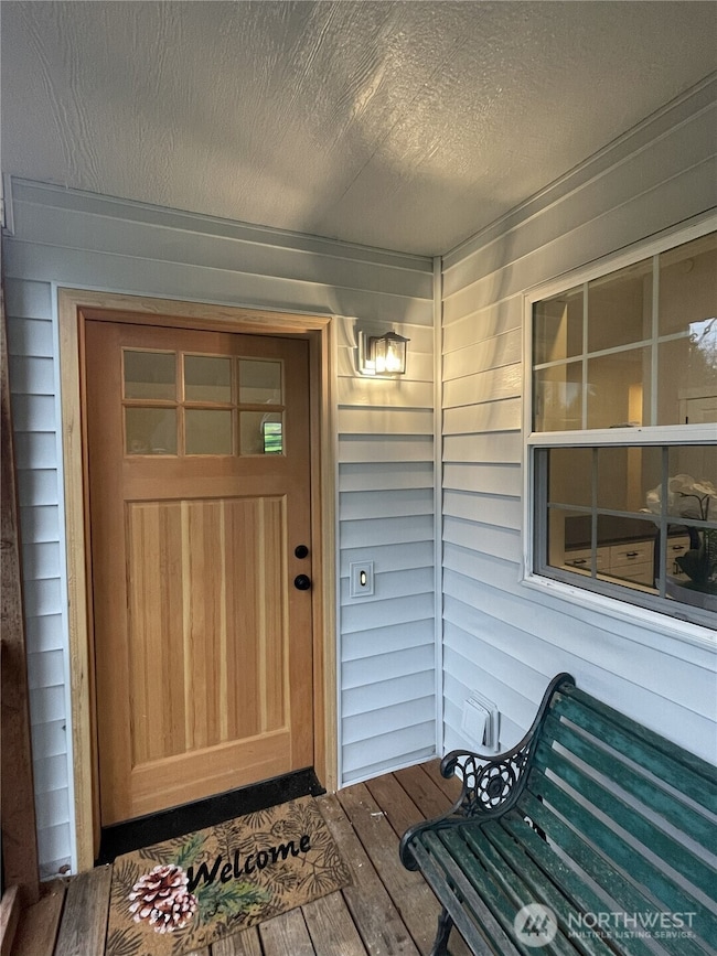 Welcome home- covered porch area and real wood front door.