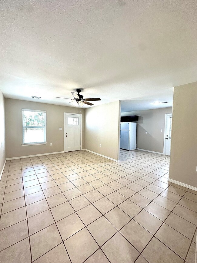 Spacious living area with plenty of natural light and open to the breakfast area.