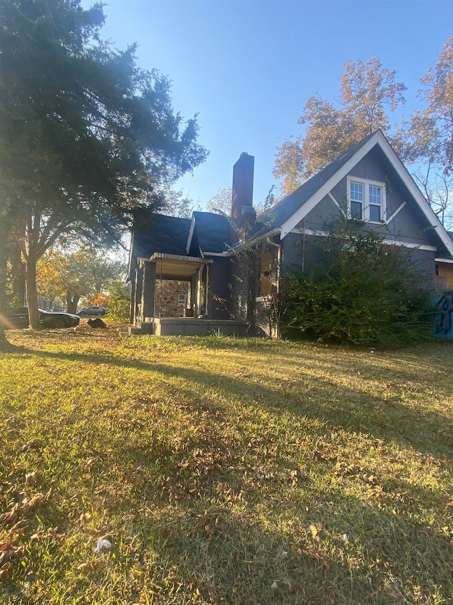 Back of house with a lawn
