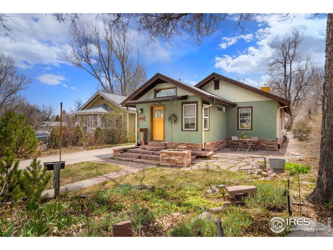Tasteful stucco front with a Transom Window for added light and a  welcoming rock entry.
