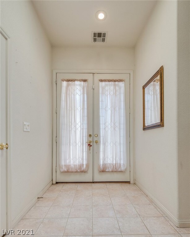 AIRY ENTRANCE WITH STAIN GLASS DOORS