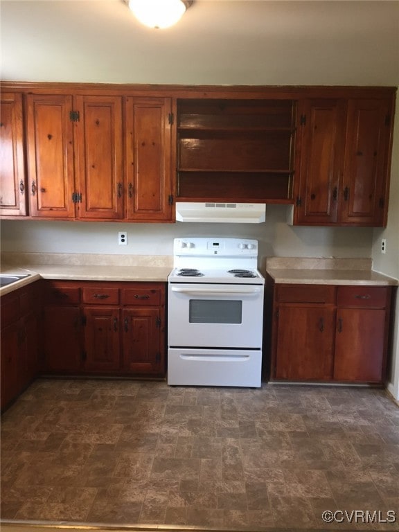 Kitchen with white electric range oven, exhaust ho