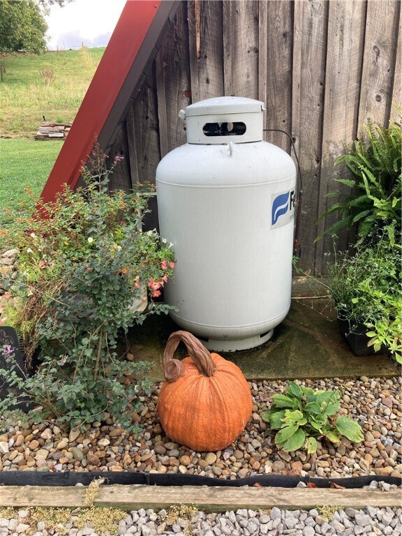 Propane tank sits to the front corner of the home.