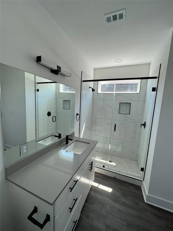 Bathroom featuring wood finished floors, vanity, 