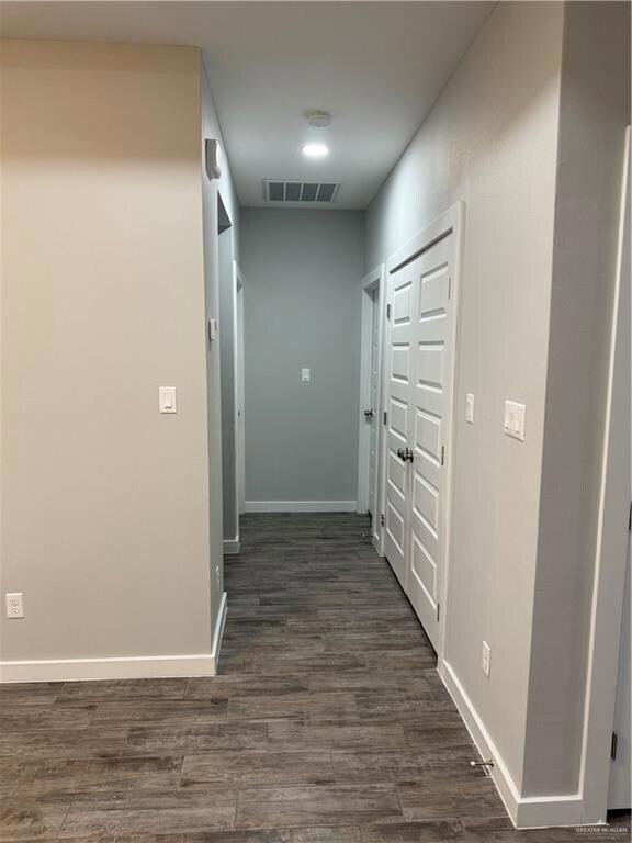 Hall with dark wood-type flooring