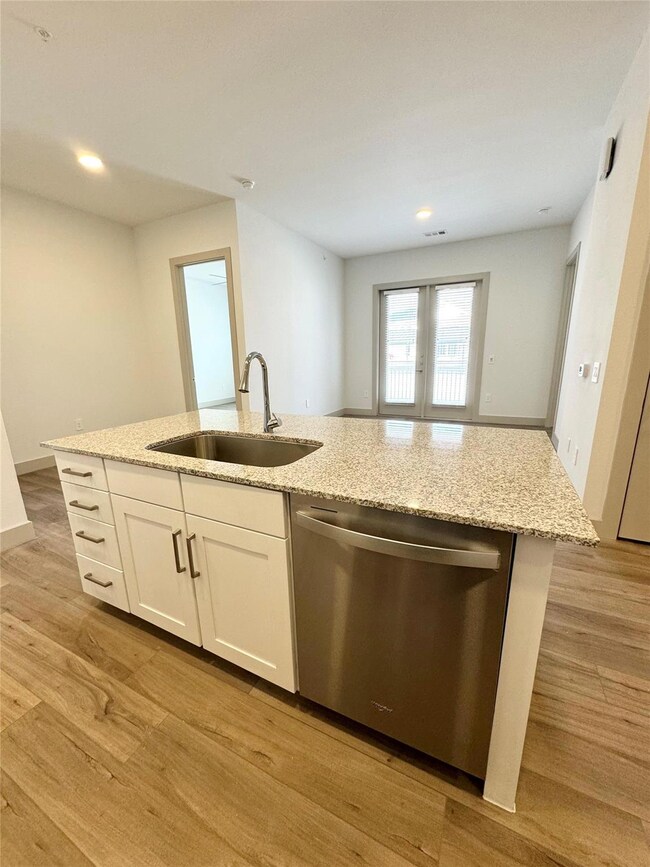 Kitchen with light wood-type flooring, white cabin