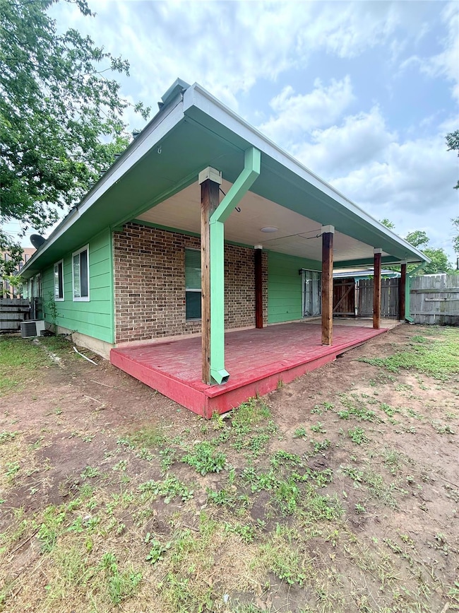 Rear view of property featuring central air condi