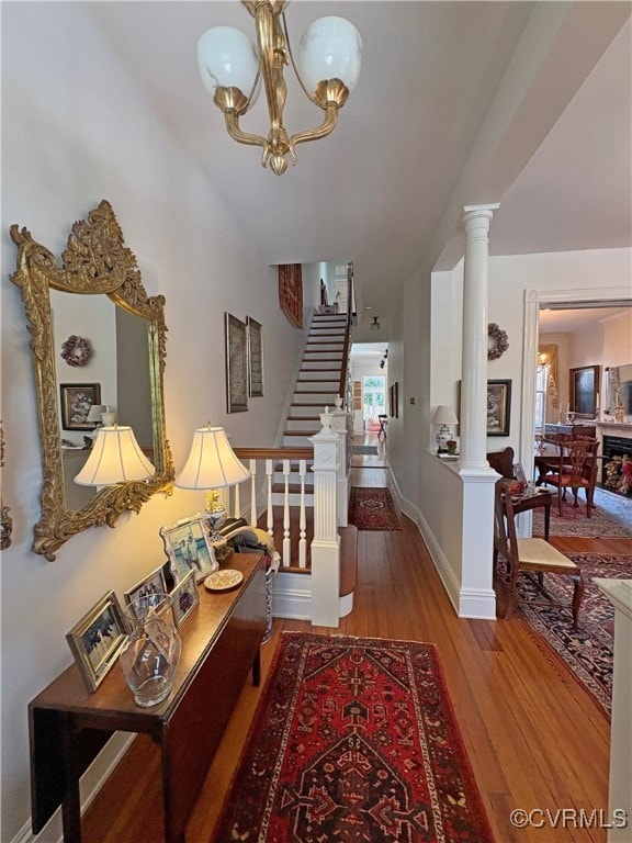 Charming Foyer with columns and chandelier.