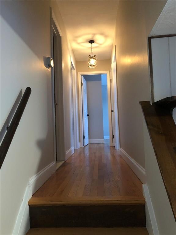 The gleaming hardwoods in the hallway leading to t