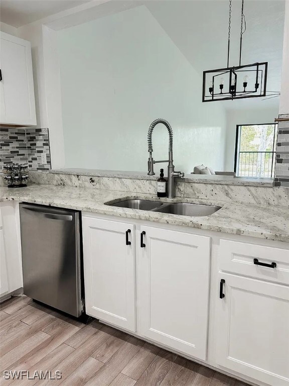 Kitchen featuring stainless steel dishwasher, a si
