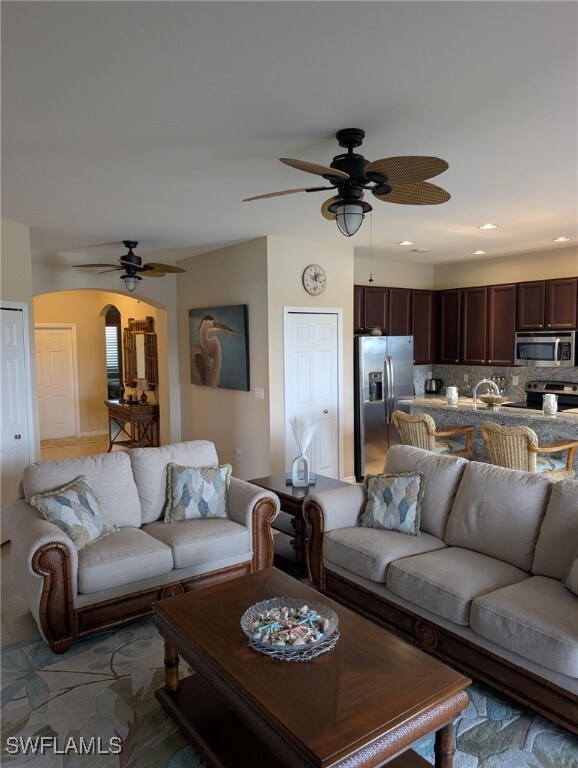 Living area with ceiling fan, recessed lighting, a