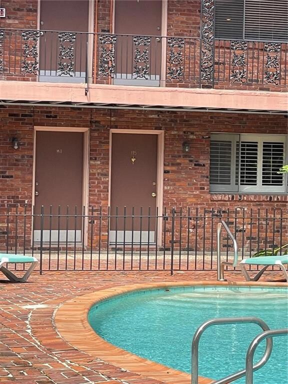 Front door of Condo #115 on the right. The pool an