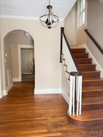 Stairs featuring ornamental molding, hardwood / wo
