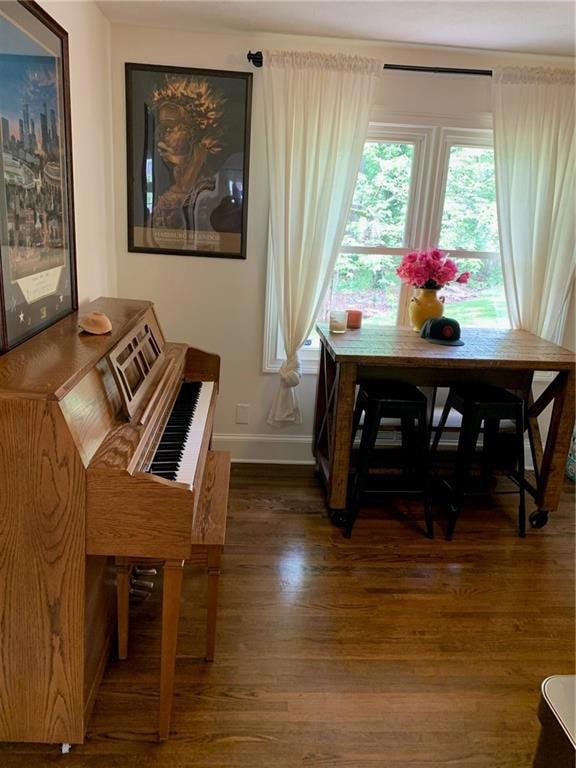 Dining space with wood finished floors and baseboards