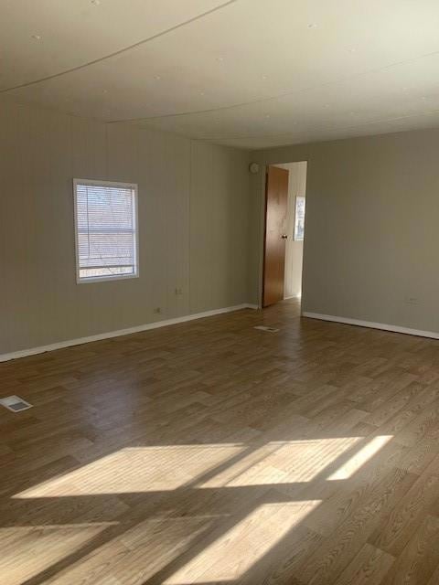 Empty room featuring wood finished floors and baseboards