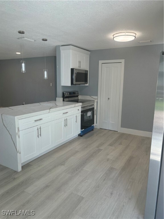 Kitchen with stainless steel electric range, a tex