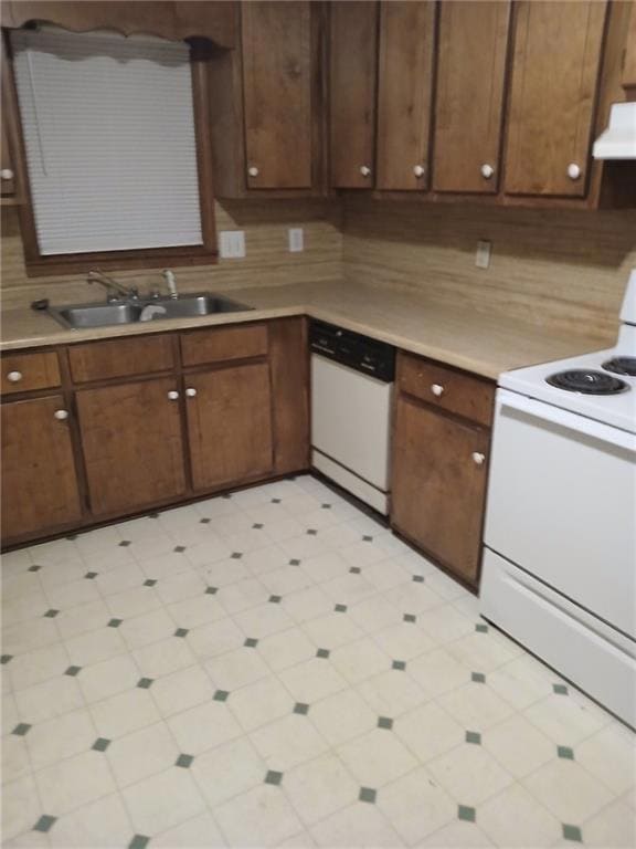 Kitchen featuring sink, dark brown cabinets, and w