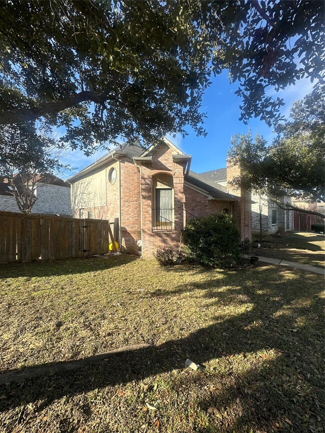 View of side of home with a yard