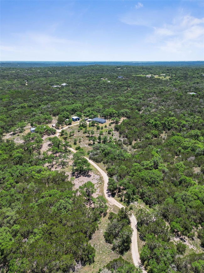 Aerial view featuring a view of trees