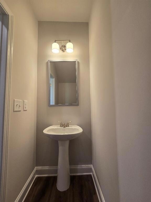 Bathroom with baseboards and wood finished floors