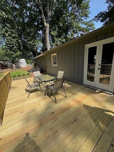 Deck featuring outdoor dining area and french doors