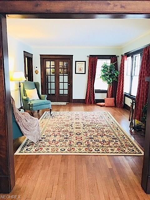 Lovely Lewis Living Room with Gorgeous Wood Floors + Fireplace, Crown Molding, Hardwood Floors, Pocket Door to Hall on Left, Bi-Fold Doors lead to Foyer ~